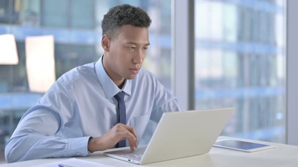 African American Businessman Get Shocked While Working on Laptop 