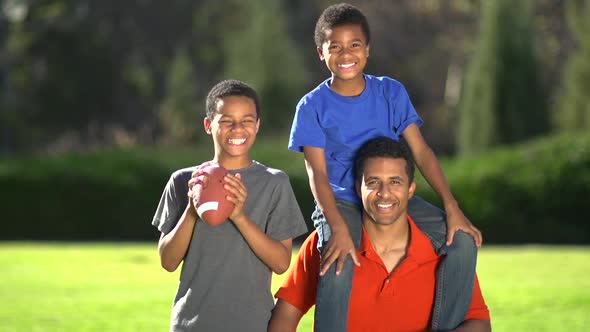 Group portrait of a father and his sons with a football