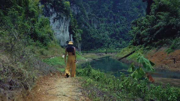 Cute Smiling Asian Girl Walking on a Trail in Cheow Lan Lake Thailand