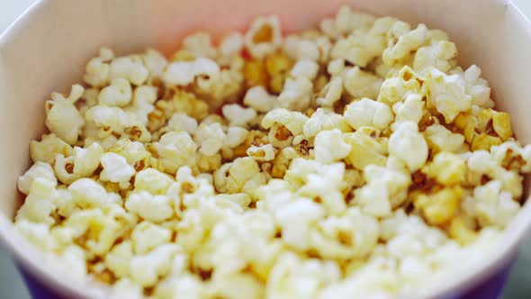 Taking popcorn from a bucket