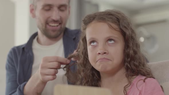 Dad Braids Hair Little Daughter The Girl Is Upset or She Does Not Like Family Relationships.