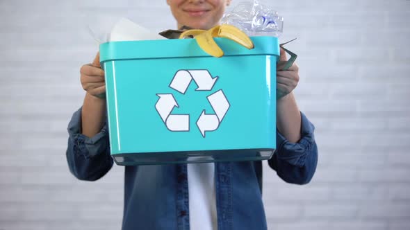 Person Holding Trash Bin With Disposable and Plastic Garbage, Waste Sorting