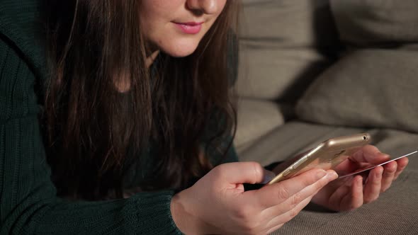 Woman with a Phone and a Bank Card