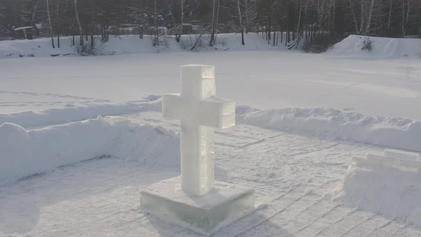 Huge ice sculpture of cross on pond or lake, feast of baptism of Lord, Epiphany.
