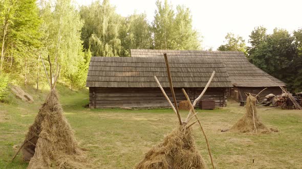 Ancient Peasant Cabin and Hay on the Yard