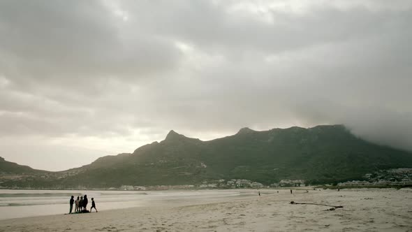 Locked shot of an empty beach at Hout Bay South Africa in the evening with cloudy sky and hazy mount