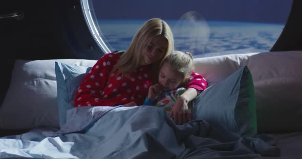 Mother and Daughter Using Smartphone in a Spaceship