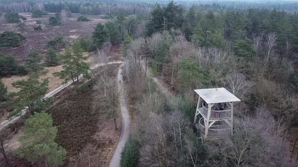 Flying with a drone over a lookout tower to spot wildlife in De Hoge Veluwe National Park in The Net