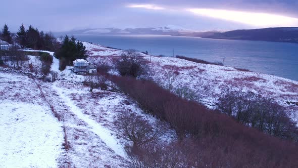 AERIAL - a contemporary aluminium home in the winter snow in Scotland