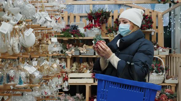 Woman in Mask Are Shopping at the Christmas Fair