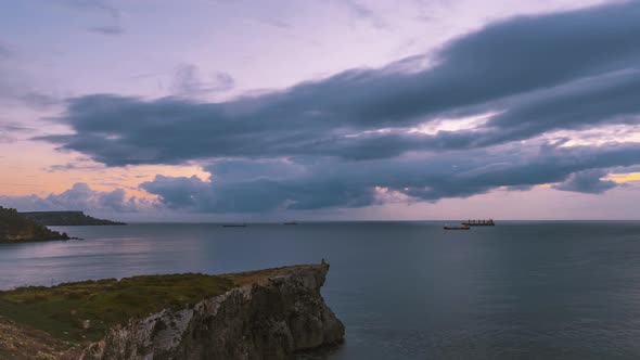 Time lapse of cloudement during sunset, high vantage point on coastline