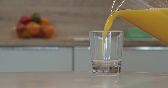 Peach Juice is Poured Into a Glass