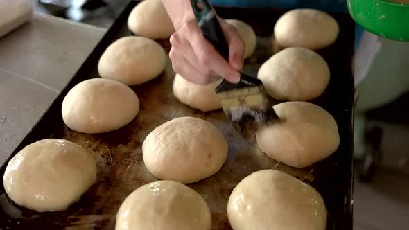 Female Baker Brushing Dough with Yolks