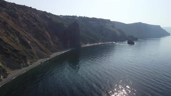 Aerial View From Above on Calm Azure Sea and Volcanic Rocky Shores