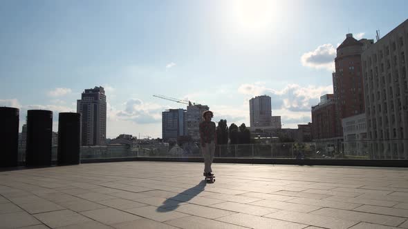 Active Man Skating on Longboard Outdoors