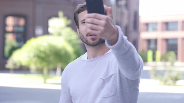 Handsome Man Taking Selfie on Phone