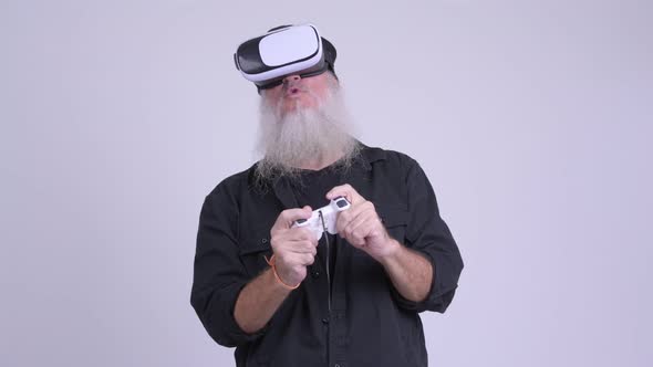 Mature Bearded Hipster Man Playing Games While Using Virtual Reality Headset