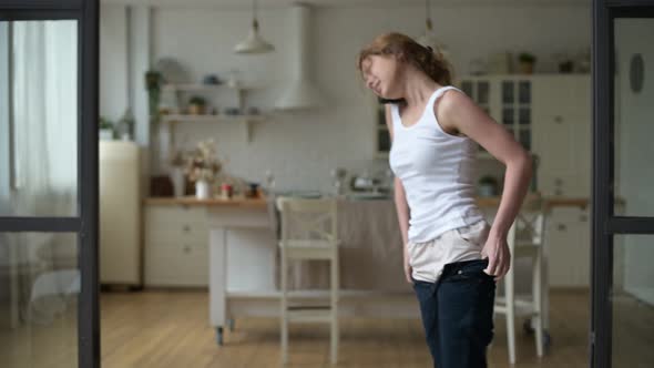 Young woman overslept without hearing the alarm clock and is hurry