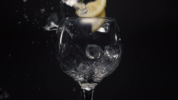 Ice Cubes Lemons Falls Empty Wineglass Closeup