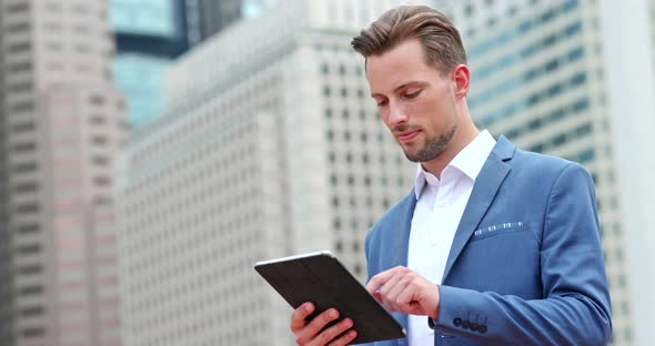 Businessman work on tablet computer in city