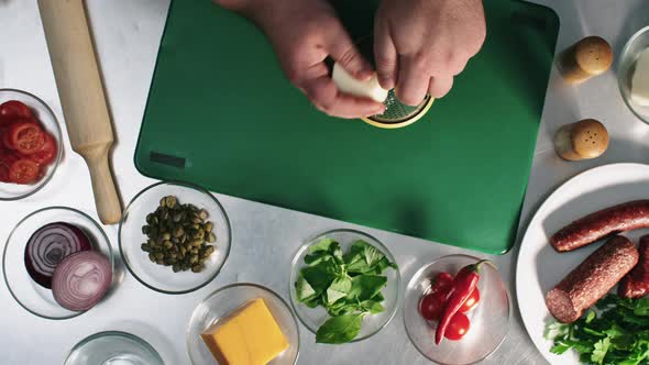 Grating Cheese when Making Pizza