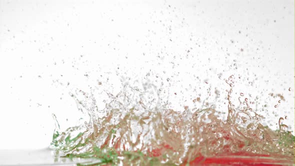 Super Slow Motion of Chilli Pepper Falls on the Water with Spray