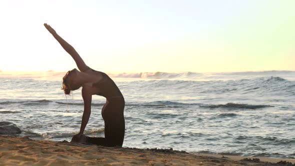 Brunette in Black Tracksuit Practices Yoga in Morning