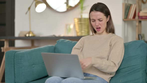 Young Woman with Laptop Having Wrist Pain on Sofa 