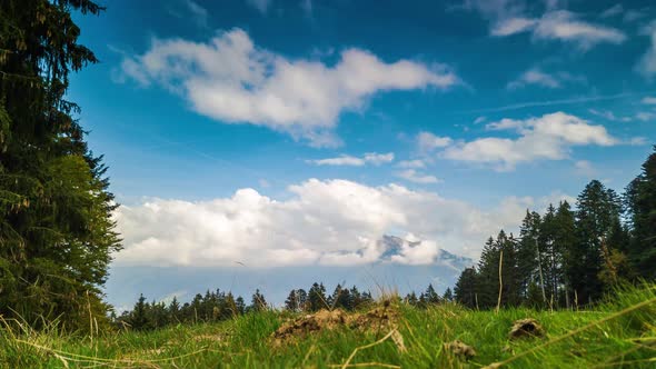 Timelapse shot in the Swiss alps of clouds passing around a mountain.