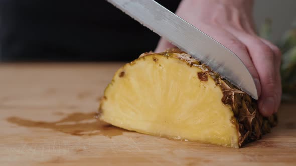 Close Up of Young Man Chef Hands Slicing a Pineapple in Kitchen Macro Super Male Female Fruits