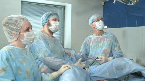 Team of doctors working together during a surgery in an