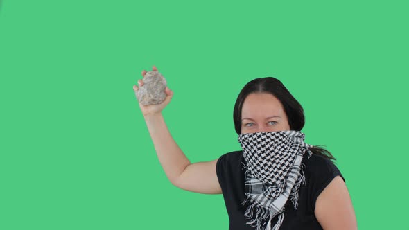 Angry Woman with Stone in Hands on National Strike on Green Background. Furious Woman in Bandana