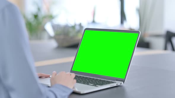 Latin Woman Using Laptop with Green Chroma Key Screen