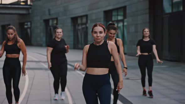 Smiling Zumba Class Dancing in the City at Night Time