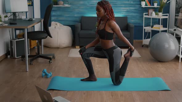 Fitness Woman with Black Skin Practicing Fitness Workout in Living Room