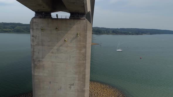 Safety Inspectors Working at Height on a Concrete Bridge Checking for Cracks