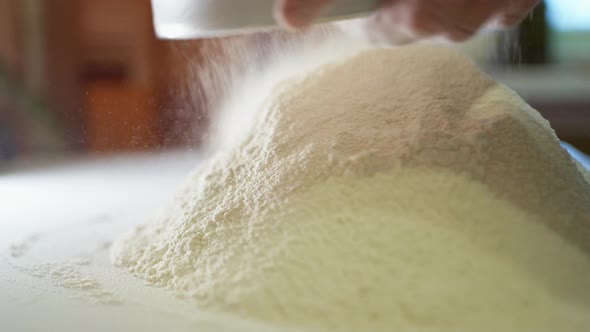 Female Hands Beautifully Sift Wheat Flour Through a Sieve