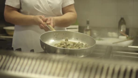 Clams Are Stirred on a Pan in the Kitchen