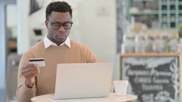 Successful Online Shopping on Laptop By Creative African Man