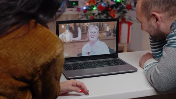 Couple Talking to Elder Woman on Video Call for Christmas