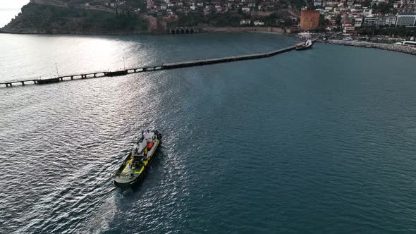 Ship tug sails out of port aerial view Turkey Alanya 4 K