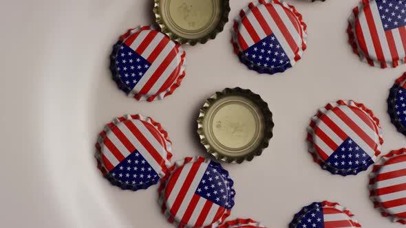 Rotating shot of bottle caps with the American flag printed on them 