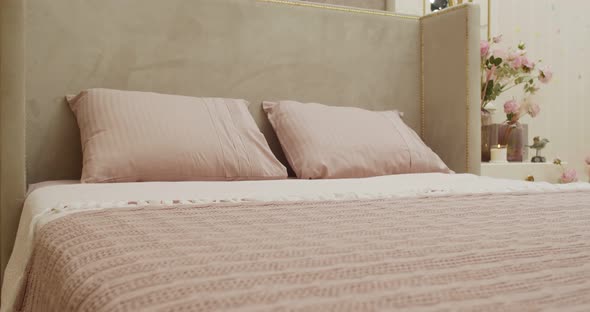 Closeup of Purple Pillows with Floral Patterns and Purple Cover on the Bed