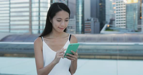 Woman use of mobile phone in the evening 