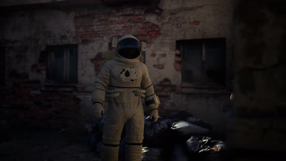 Lost Astronaut Near Abandoned Industrial Buildings of Old Factory