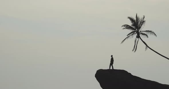 Man Climbing on Cliff