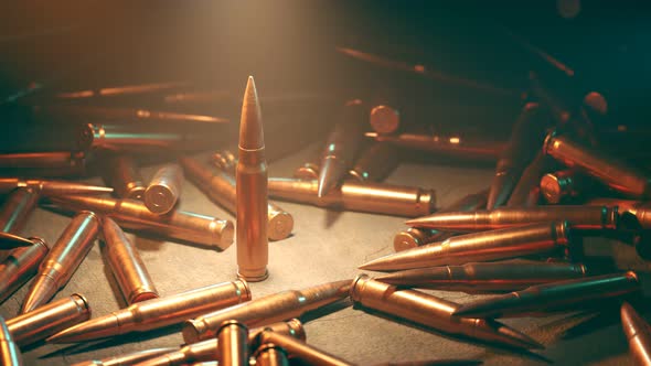 Closeup of the one standing bullet in the spotlight surrounded by scattered ammo