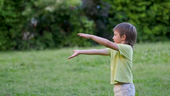 Little Kid Plays Frisbee on Grass Lawn