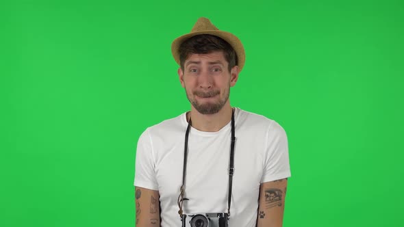 Portrait of Confident Guy Is Saying Oops and Shrugging . Green Screen