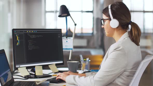 Programmer in Headphones Working on Computer 16